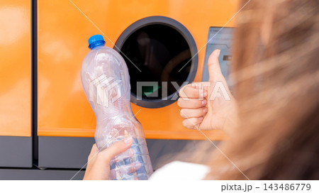 Bottle recycling concept with woman near return station. 143486779