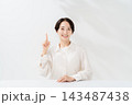 人差し指を立てて説明する笑顔の女性 143487438