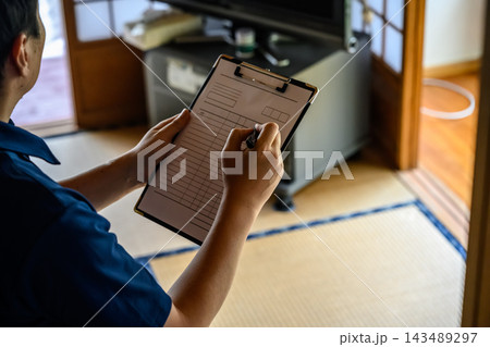 バインダーに記入する男性の作業風景 143489297