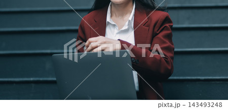 Asian woman in sitting at stairway outdoor have a stressed, after being laid off unemployed. Desperate be out of work. 143493248