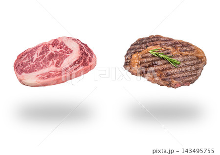 Raw marbled ribeye steak beside a grilled steak with rosemary floating above soft shadows on a white background 143495755