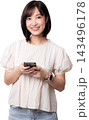 Happy smiling asian woman holding smartphone using modern mobile application with artificial intelligence technology isolated on transparency background looking at camera 143496178