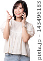 Happy smiling asian woman talking on smartphone pointing finger towards artificial intelligence technology solution with cheerful expression isolated on transparency background 143496183