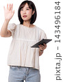 Young focused asian woman touching invisible virtual interface using artificial intelligence technology device showing curiosity and modern digital innovation concept 143496184