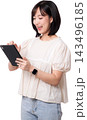 Happy smiling young asian woman holding digital tablet device exploring artificial intelligence online platform application isolated against plain transparency background studio shot 143496185