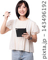Happy smiling young asian woman holding digital tablet pen working on artificial intelligence concept standing isolated on transparency background looking at camera 143496192