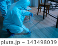 Forensic expert collecting a blood sample at a crime scene for laboratory analysis, DNA testing, criminal investigation, evidence examination, and justice. 143498039