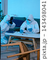 Forensic expert collecting a blood sample at a crime scene for laboratory analysis, DNA testing, criminal investigation, evidence examination, and justice. 143498041