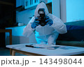 Forensic expert collecting a blood sample at a crime scene for laboratory analysis, DNA testing, criminal investigation, evidence examination, and justice. 143498044