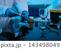 Forensic expert collecting a blood sample at a crime scene for laboratory analysis, DNA testing, criminal investigation, evidence examination, and justice. 143498049