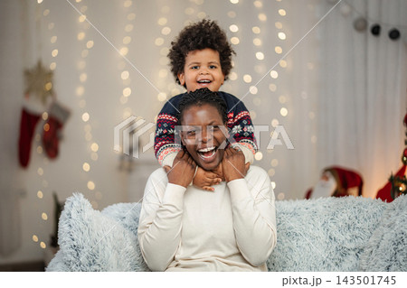 Mother and child celebrating Christmas holidays together at home Mother and child celebrating Christmas holidays together at home 143501745