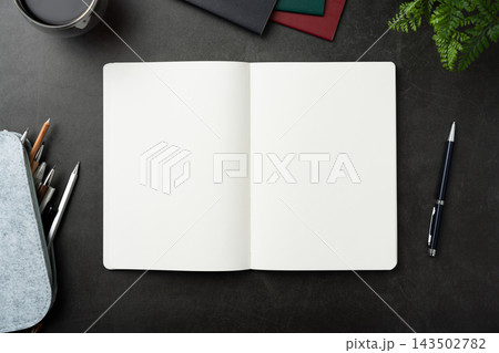 Top view of opened black hardcover notebook with pencil case and office stationery on dark stone background with copy space Top view of opened black hardcover notebook with pencil case and office stationery on dark stone background with copy space 143502782
