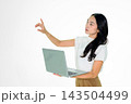 Asian Girl Holding Laptop and Pointing on White Background Asian Girl Holding Laptop and Pointing on White Background 143504499
