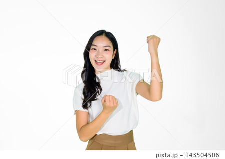 Excited Asian Girl Celebrating Victory with Raised Fist on White Background 143504506