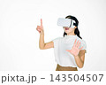 Young Asian Woman Using VR Headset Reaching Hands in Virtual Reality Experience on White Background Young Asian Woman Using VR Headset Reaching Hands in Virtual Reality Experience on White Background 143504507