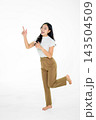 Happy Asian Girl Pointing Up and Posing Playfully on White Background Full Body Studio Shot Happy Asian Girl Pointing Up and Posing Playfully on White Background Full Body Studio Shot 143504509
