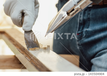 Carpenter at work, restoring an old wooden window. Carpentry. Carpenter at work, restoring an old wooden window. Carpentry. 143504904