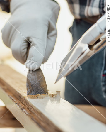 Carpenter at work, restoring an old wooden window. Carpentry. Carpenter at work, restoring an old wooden window. Carpentry. 143504907