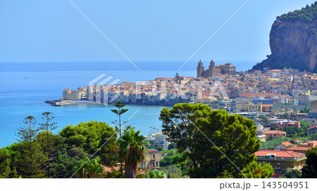 Cefalu, Italy. 22 August 2026. A panoramic view of the old town, situated right by the sea and featuring beautiful architecture. The La Rocca rock towers over the town. Cefalu, Italy. 22 August 2026. A panoramic view of the old town, situated right by the sea and featuring beautiful architecture. The La Rocca rock towers over the town. 143504951