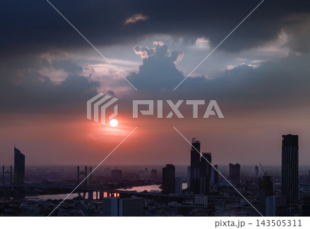 A breathtaking high-angle view captures the dramatic interplay of light and shadow over the Bangkok skyline at dusk. 143505311