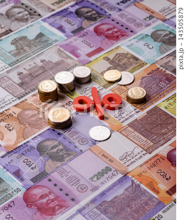 The percentage sign on cash as a concept for inflation or tax liabilities. The percentage sign 143505879