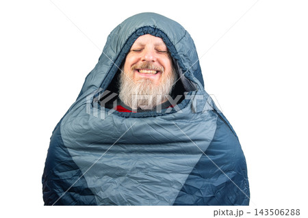 Person smiling while wrapped in a sleeping bag indoors with a joyful expression Person smiling while wrapped in a sleeping bag indoors with a joyful expression 143506288