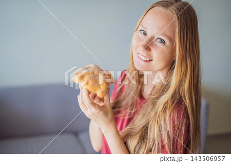 Happy woman presenting a traditional Mexican pan de muerto. Happy woman presenting a traditional Mexican pan de muerto. 143506957