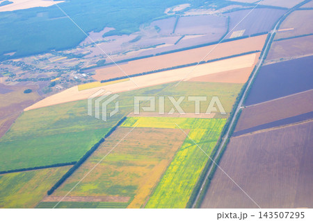 Farm fields and landscape view from above in rural area showing different colors and patterns Farm fields and landscape view from above in rural area showing different colors and patterns 143507295
