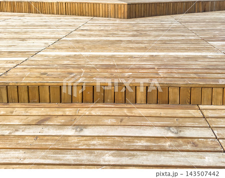 Multi level wooden flooring with weathered planks and stepped terrace details 143507442