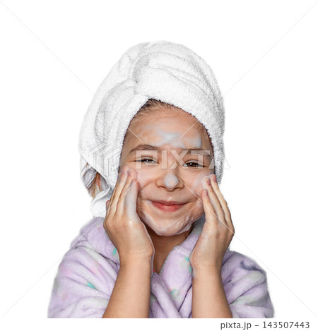 Smiling girl washing face with foamy cleanser in towel after bath morning skincare routine Smiling girl washing face with foamy cleanser in towel after bath morning skincare routine 143507443