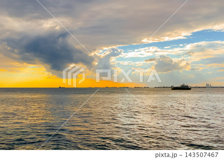 View of the amazing dramatic sunset sky over the sea surface in the evening View of the amazing dramatic sunset sky over the sea surface in the evening 143507467