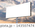 Blank white billboard against the warm sunset sky with clouds - mock up 143507474
