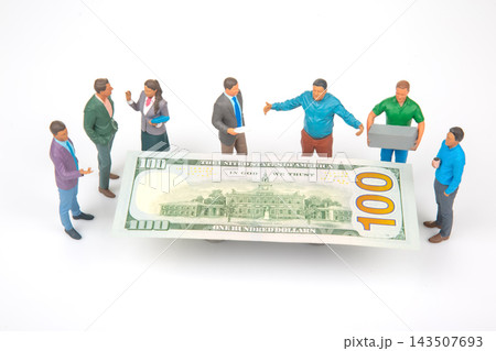 Miniature people discussing around a large one-hundred-dollar bill on a white background Miniature people discussing around a large one-hundred-dollar bill on a white background 143507693