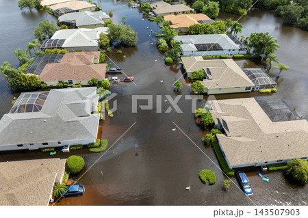 Hurricane flooded cars and homes in residential community in Florida, USA. Aftermath of natural disaster Hurricane flooded cars and homes in residential community in Florida, USA. Aftermath of natural disaster 143507903