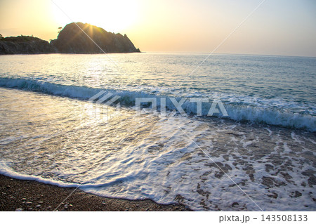 Sunrise over the sea with waves hitting the shore in Turkey 143508133