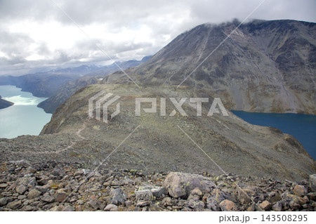 Mountain landscape in Norway with lakes and rocky terrain under a cloudy sky 143508295