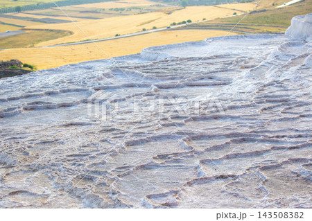 Travertine terraces at Pamukkale in Turkey attract visitors during a sunny day Travertine terraces at Pamukkale in Turkey attract visitors during a sunny day 143508382