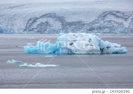 Iceberg floating in a glacier lagoon in Iceland on a cloudy day 143508390