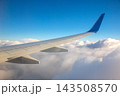 View of an airplane wing above white clouds during daytime 143508570