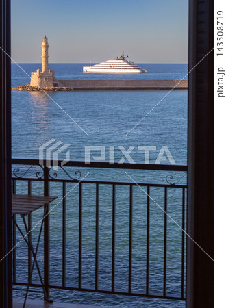 Luxury Superyacht and Venetian Lighthouse in Chania, Crete, Greece Luxury Superyacht and Venetian Lighthouse in Chania, Crete, Greece 143508719