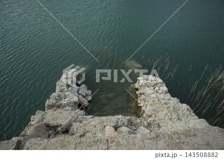Submerged Stone Ruins Entering Clear Turquoise Water of a Lake Reservoir.Amadorio Reservoir, Alicante, Spain Submerged Stone Ruins Entering Clear Turquoise Water of a Lake Reservoir.Amadorio Reservoir, Alicante, Spain 143508882