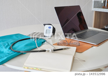 Healthcare equipment and laptop arranged for remote medical work 143512996