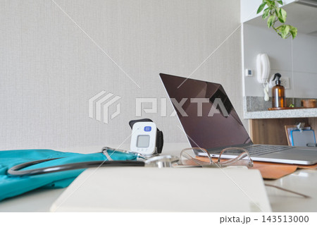 Remote medical consultation setup with laptop and stethoscope 143513000