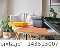 Cozy home workspace with crafting tools and plants 143513007