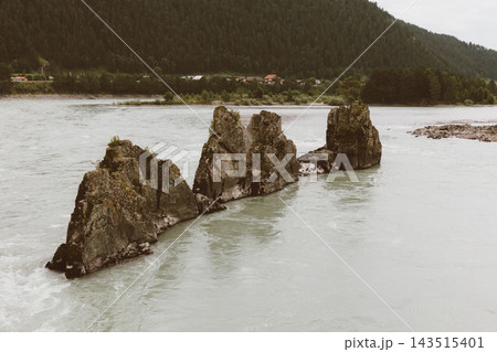 Jagged Dragon Teeth rock formations rising from the turquoise Katun River waters 143515401