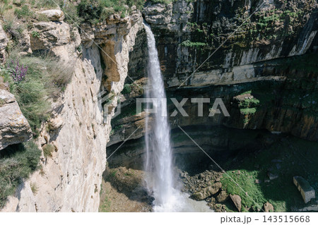 Scenic view of powerful Itlyatlyar waterfall cascading down steep rocky canyon cliffs 143515668