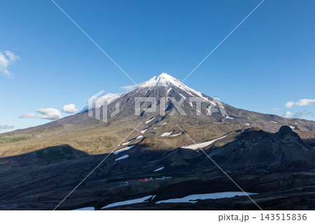 Snow capped peak of Koryaksky volcano rising above the volcanic plateau Snow capped peak of Koryaksky volcano rising above the volcanic plateau 143515836