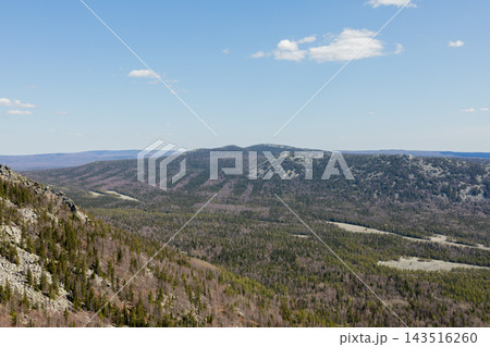 Panoramic view of mountain ranges and pine forest in Taganay National Park Panoramic view of mountain ranges and pine forest in Taganay National Park 143516260