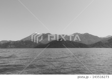 Black and white landscape view across Lake Skadar with distant mountains 143516273