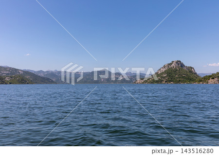 Panoramic view over Lake Skadar surrounded by green mountains 143516280